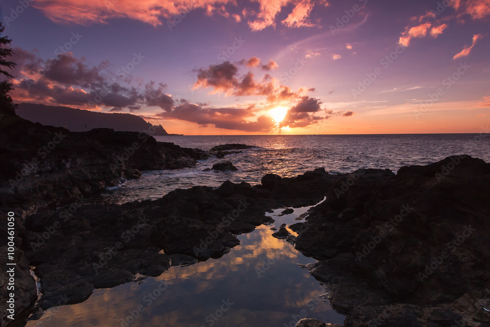 Beautiful sunset along the lava rock coast of Kauai Hawaii