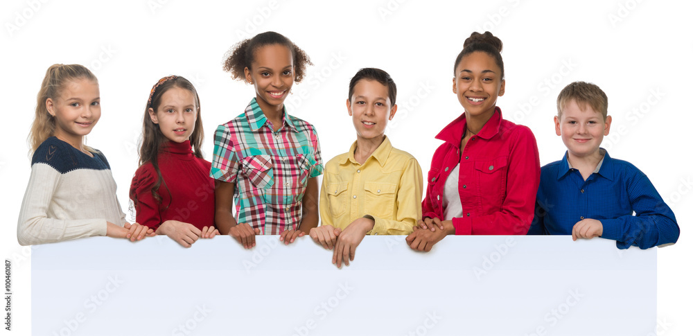 children of different complexion holding an empty blank with thumbs up children of different complexion holding an empty blank with thumbs up