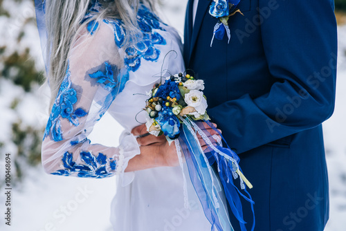 groom in a blue suit and bride in white in the mountains Carpath