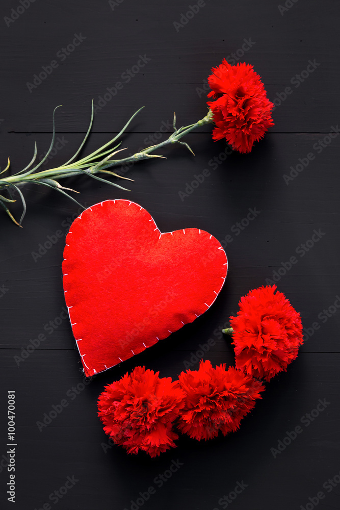 Still life of red carnations and handmade heart Still life of red carnations and handmade heart