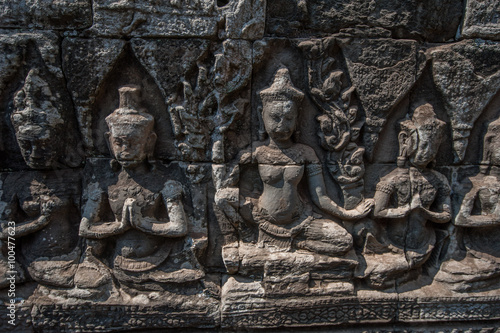 Carved stone figures on the wall at Bayon Temple, Angkor Wat, Cambodia