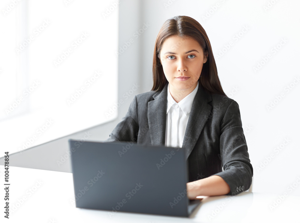 Portrait of young pretty business woman with laptop in the offic Portrait of young pretty business woman with laptop in the offic