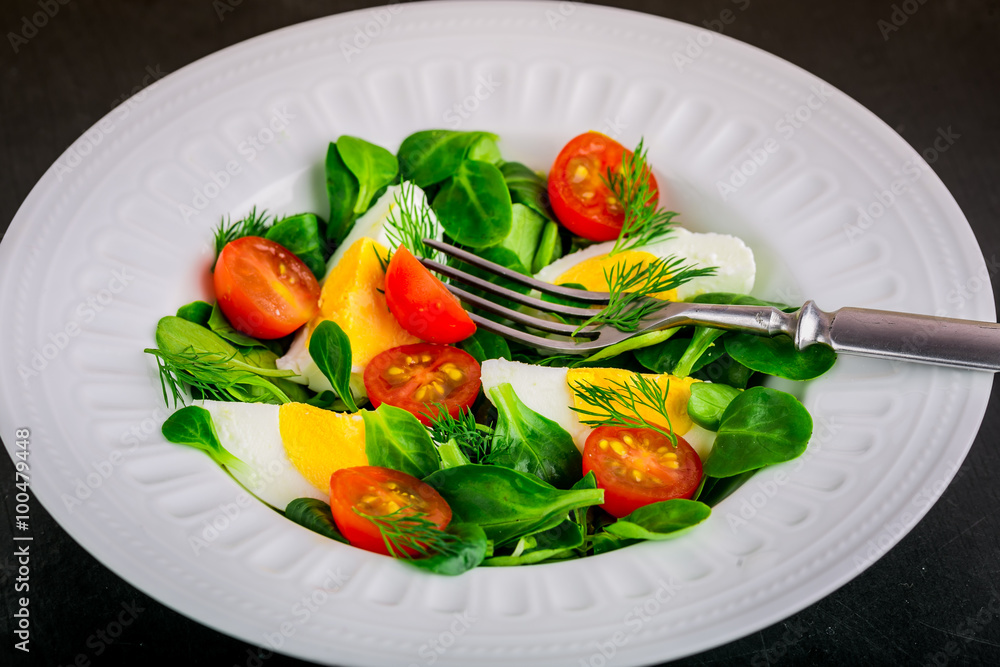 Fresh green salad with lamb's lettuce, cherry tomatoes and eggs Fresh green salad with lamb's lettuce, cherry tomatoes and eggs