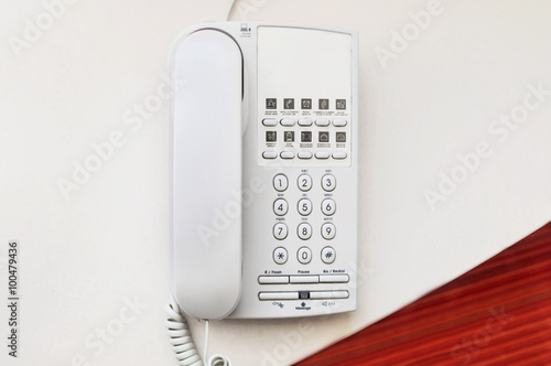 Telephone on desk in hotel room