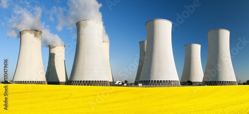 Nuclear power plant with field of rapeseed photo