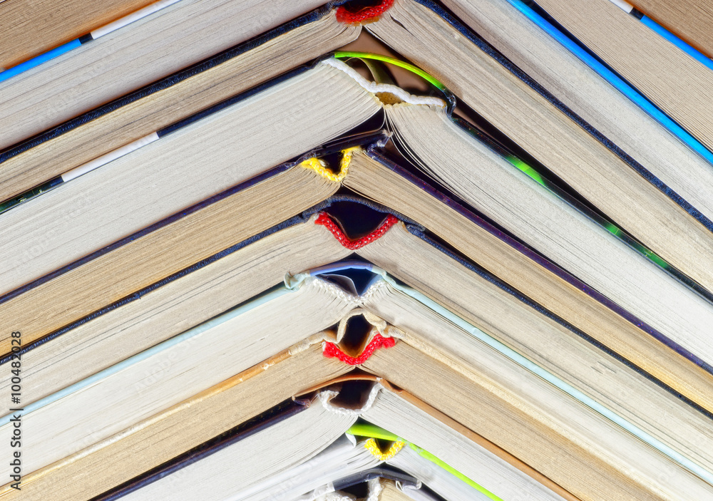 Fototapeta premium Open book lying on a shelf in the library