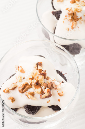 Dessert with prune, walnuts and whipped cream