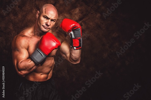 Composite image of portrait of boxer with red gloves