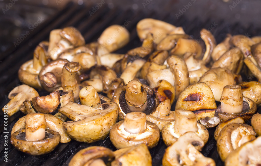 mushrooms grilling in the kitchen at the restaurant mushrooms grilling in the kitchen at the restaurant