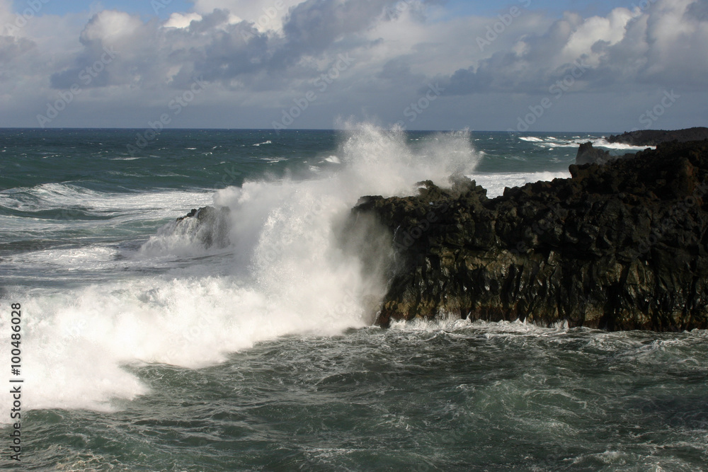 Waves crashing against cliffs