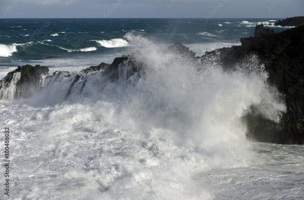 Waves crashing against cliffs