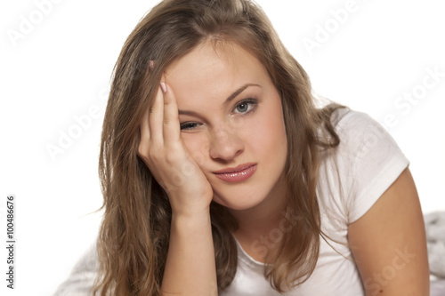 disappointed young blonde posing lying on her hands