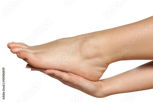 female hand holds the bare female foot © vladimirfloyd