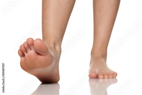 bare female feet on a white floor © vladimirfloyd