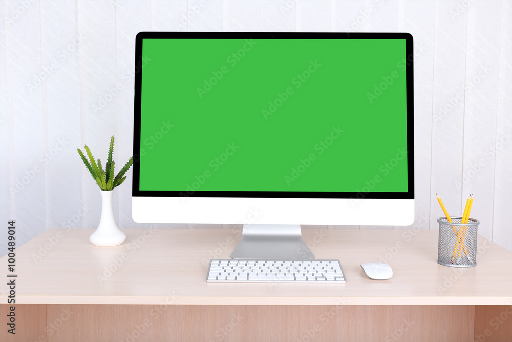 Fototapeta premium Modern computer with green screen, on table