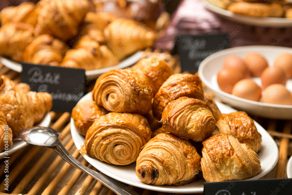 croissant plate on the table in a bakery store, ready to be served croissant plate on the table in a bakery store, ready to be served