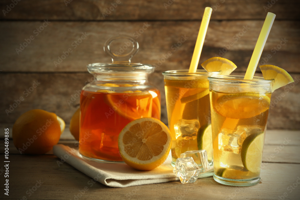 Iced tea with lemon and grapefruit on wooden background Iced tea with lemon and grapefruit on wooden background