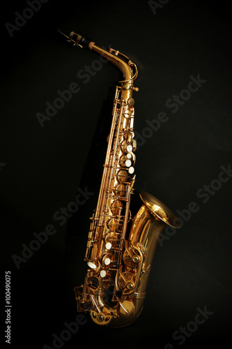 Beautiful golden saxophone on black background