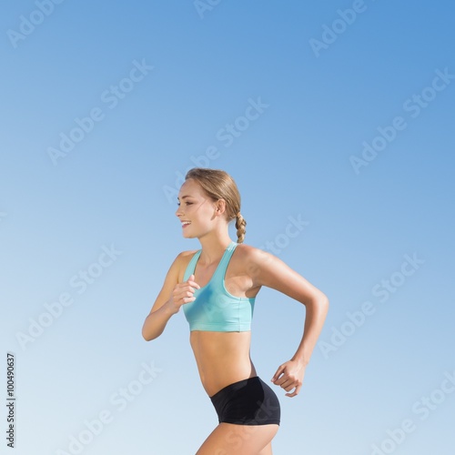 Fototapeta Naklejka Na Ścianę i Meble -  Composite image of fit woman jogging 
