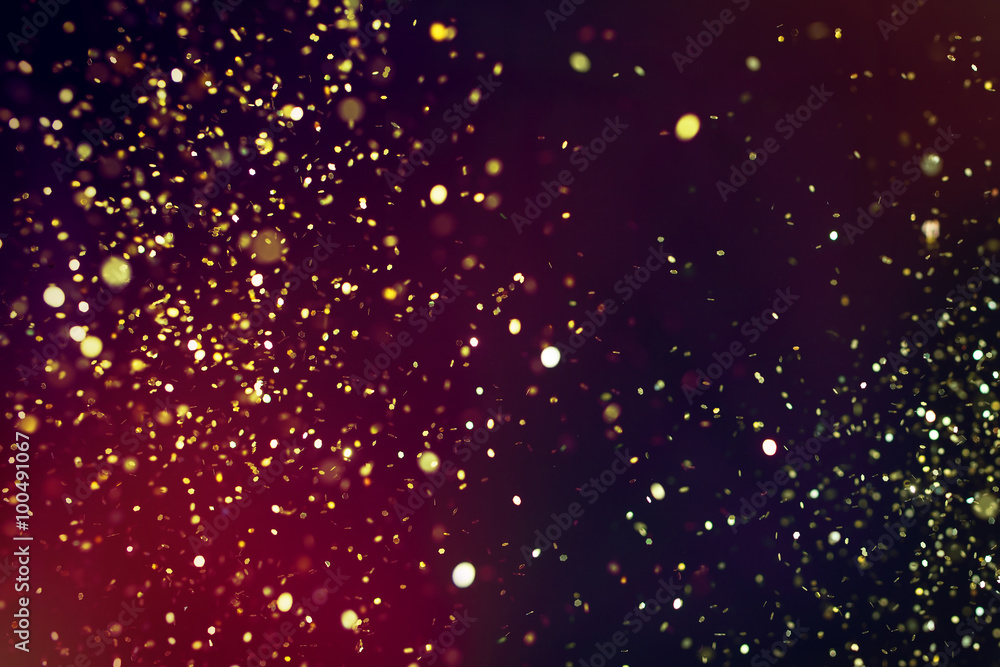 Photo of golden glitter on a black background. Golden explosion