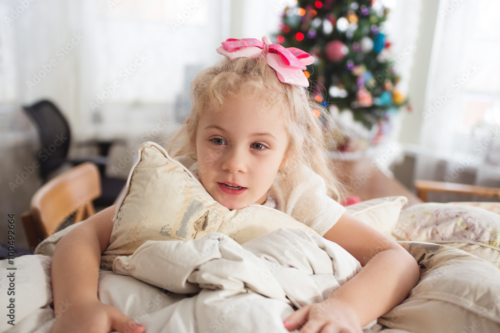 Photo of happy child girl with pillows before Christmas. Photo of happy child girl with pillows before Christmas.