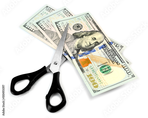 Scissors cut dollar banknotes, isolated on white