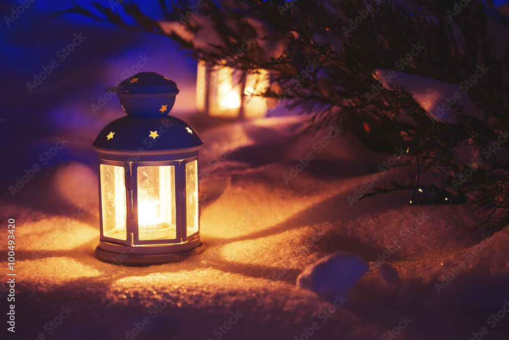 Two Lantern with burning candle on snow in the evening. Tinted p - obrazy, fototapety, plakaty 