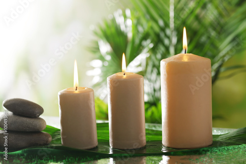 Spa composition of candles  stones and bamboo on blurred background
