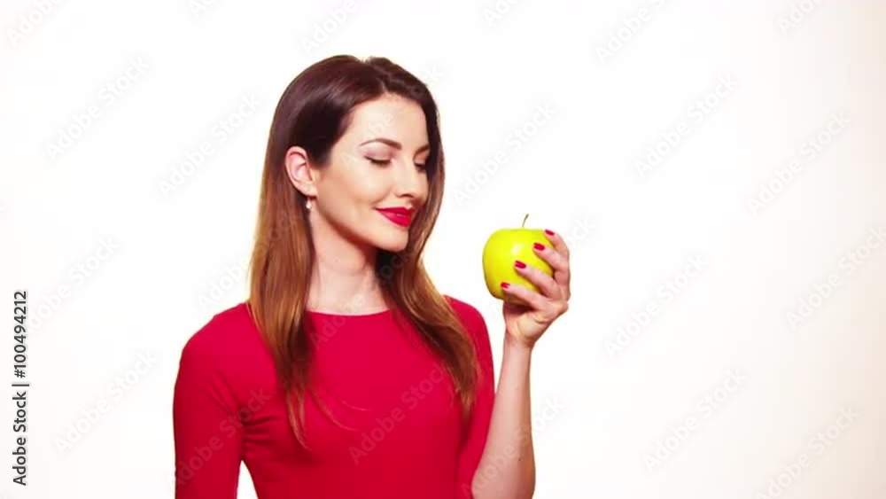 Positive Female Biting a Big Green Apple Fruit Smiling on White Background Positive Female Biting a Big Green Apple Fruit Smiling on White Background