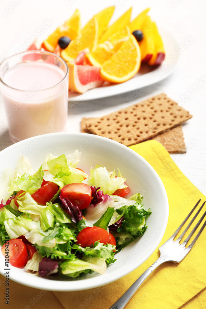 Tasty oatmeal and vegetable salad on wooden background. Healthy eating concept. Tasty oatmeal and vegetable salad on wooden background. Healthy eating concept.