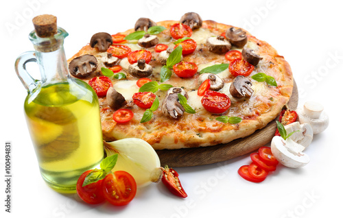 Tasty pizza and fresh vegetables on round wooden board, close up
