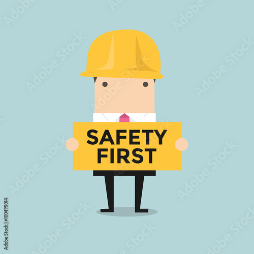 Businessman holding safety first sign vector photo