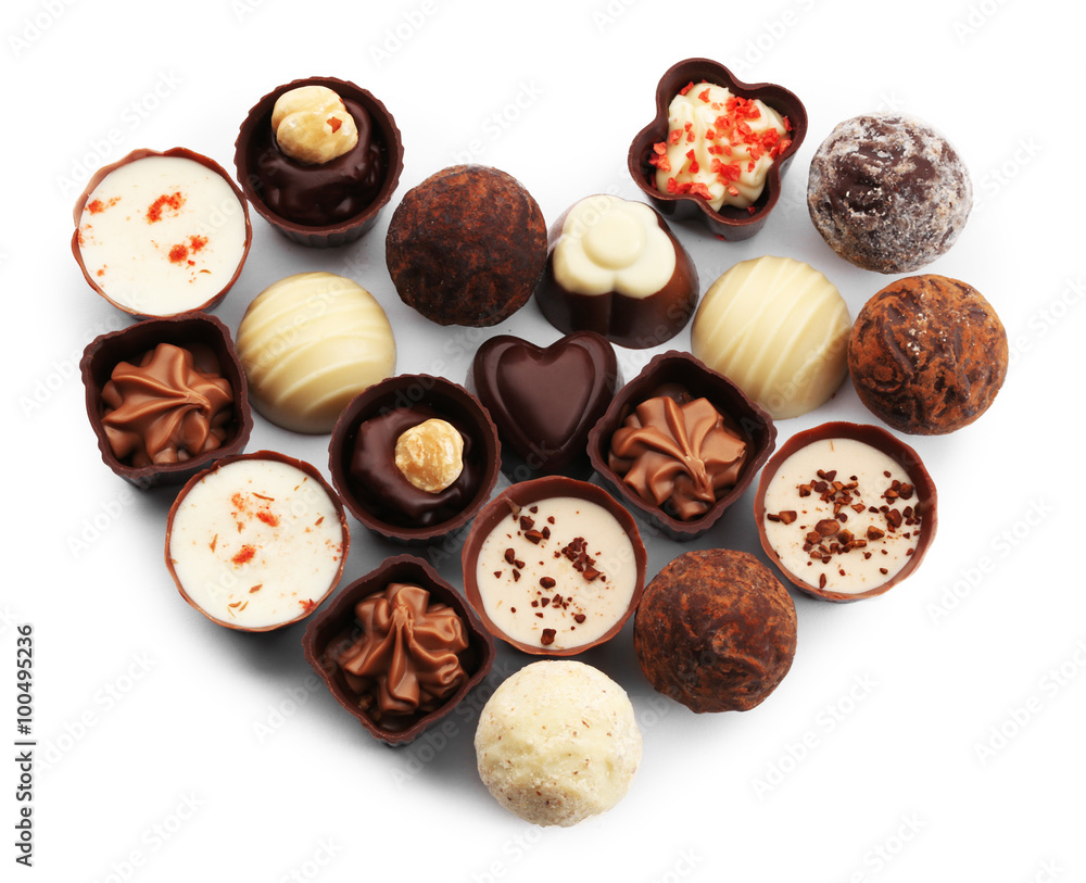 Obraz premium Heart-shaped collection of chocolate candies and sweets, isolated on white