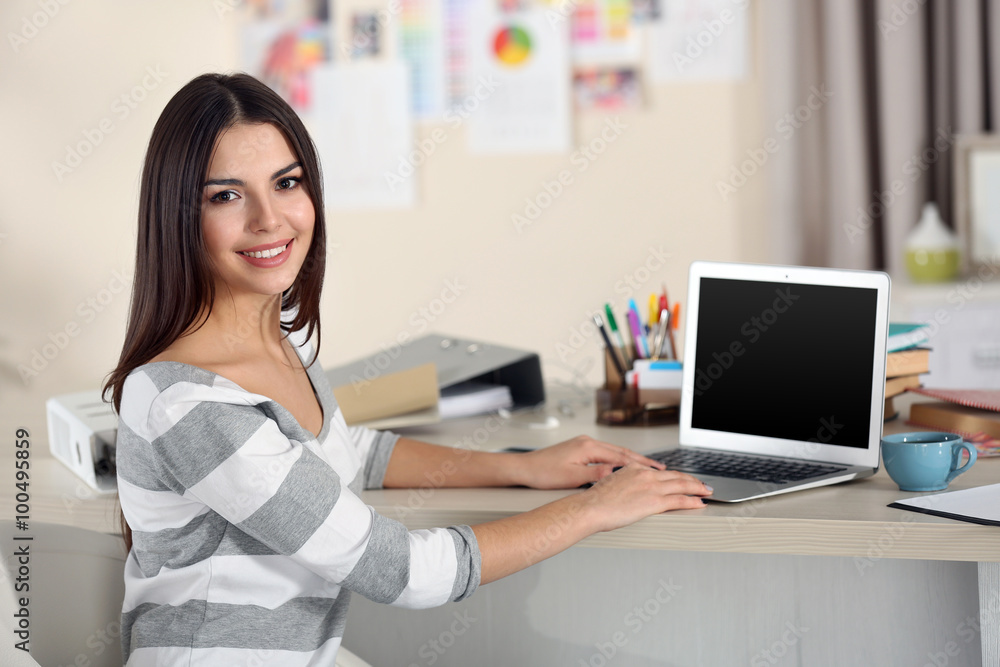 A beautiful young woman working at home as a freelancer A beautiful young woman working at home as a freelancer
