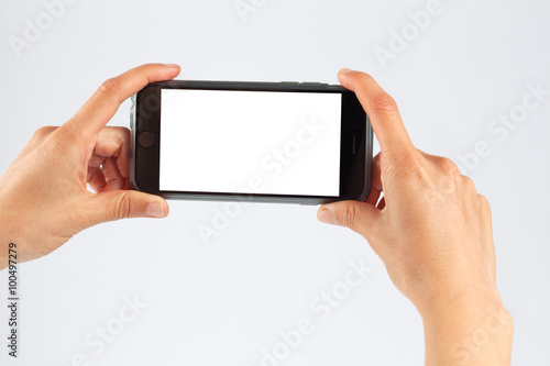 Female hands holding mobile phone horizontally