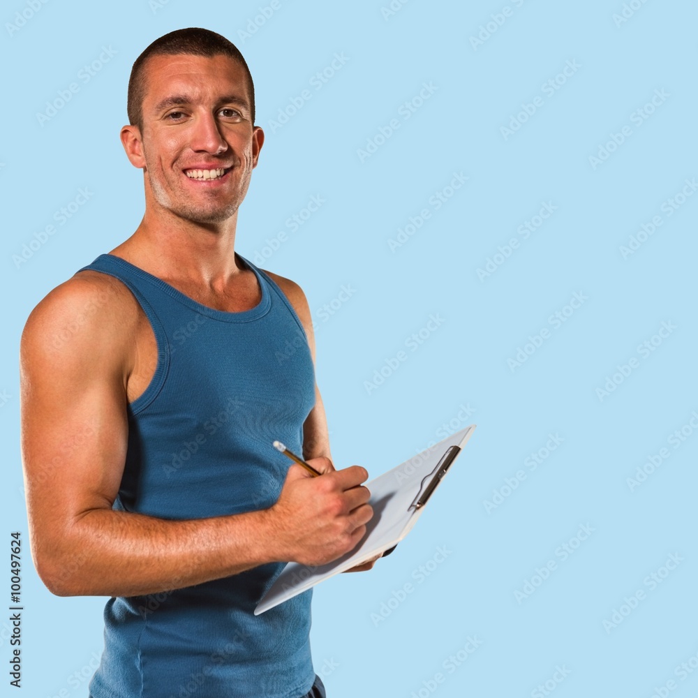 Confident sports coach writing on clipboard Confident sports coach writing on clipboard