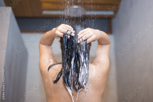 woman washing hair with shampoo