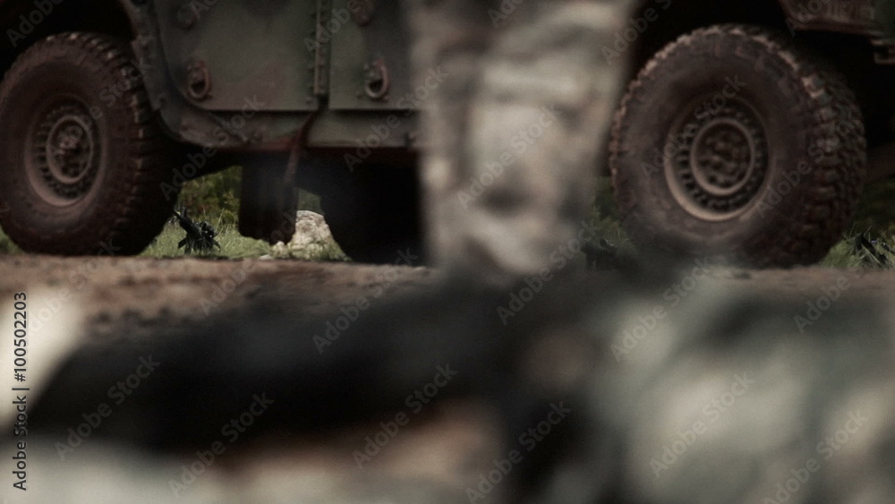 Ground level shot of a machine gun, near a military jeep. Ground level shot of a machine gun, near a military jeep.