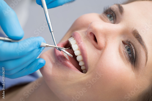 Dentist examining a patient s teeth in the dentist.