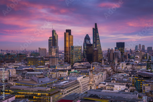 Skyline of Business district of London at dusk with beautiful colorful sky and Canary Wharf at the background