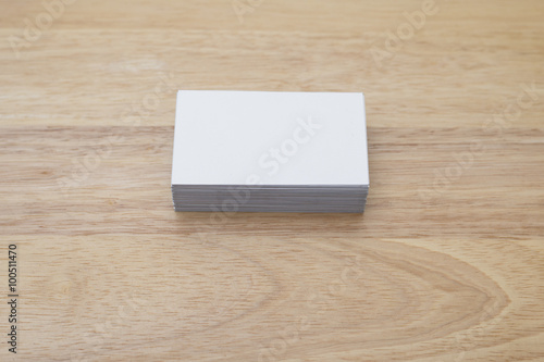 blank business cards stack up on wooden table