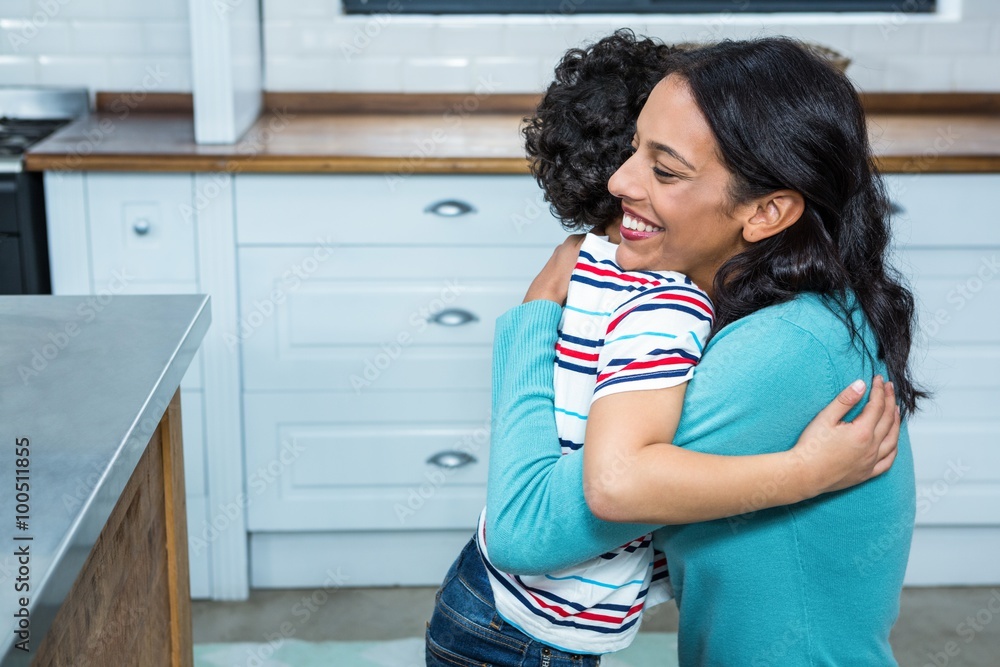 Smiling mother and son hugging Smiling mother and son hugging