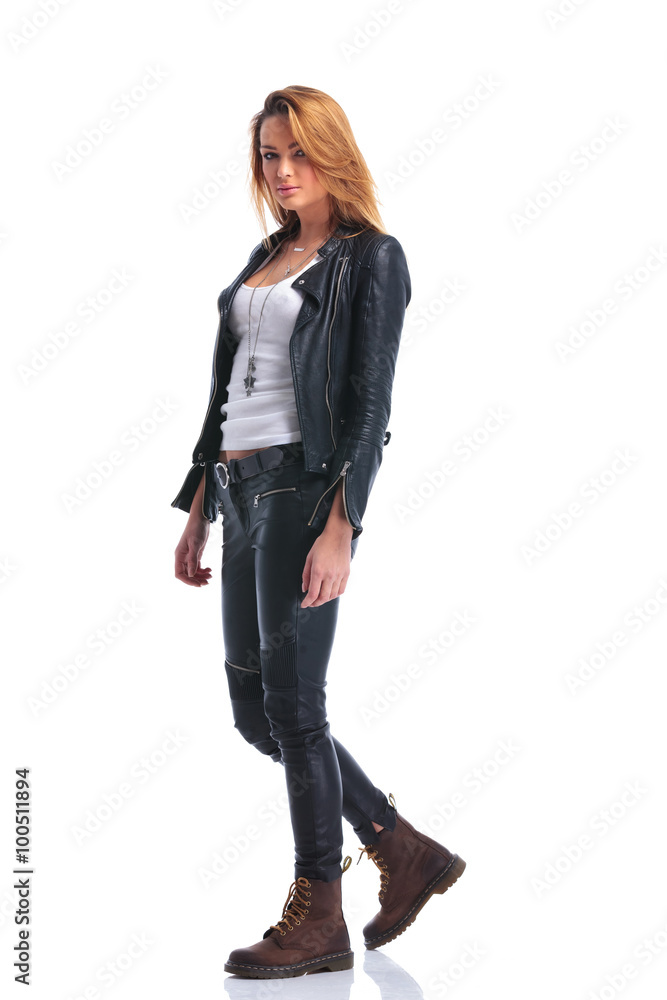 model pose in leather jacket while walking in studio and looking model pose in leather jacket while walking in studio and looking