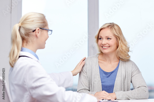 doctor talking to woman patient at hospital