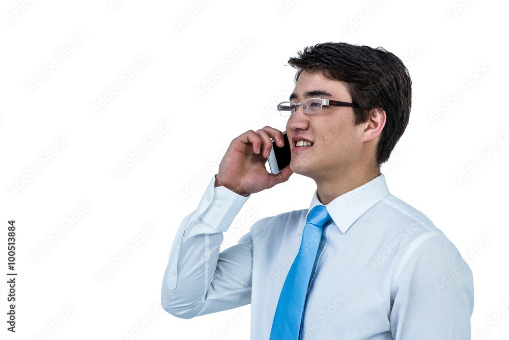 Smiling asian businessman using his telephone Smiling asian businessman using his telephone