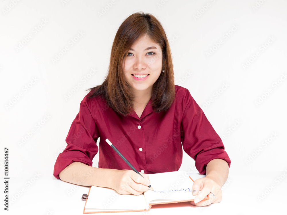 Asian women writing a pocket book Asian women writing a pocket book
