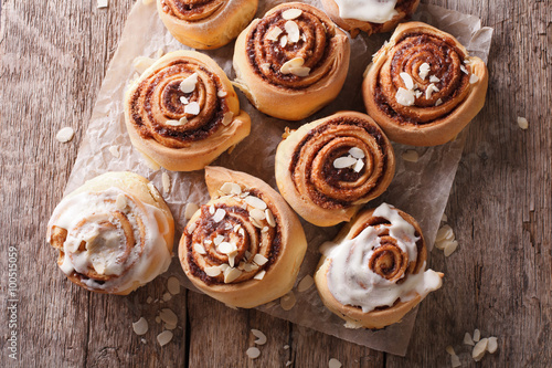 Cinnamon rolls with almond close up on the table. horizontal top view 
