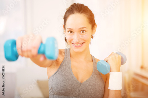 Young attractive girl doing exercise at home