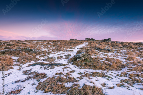 Snow on granite hills at sunrise