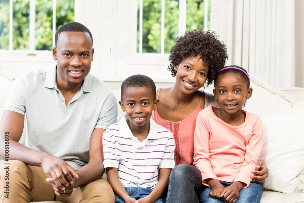 Smiling family sitting on the couch together Smiling family sitting on the couch together